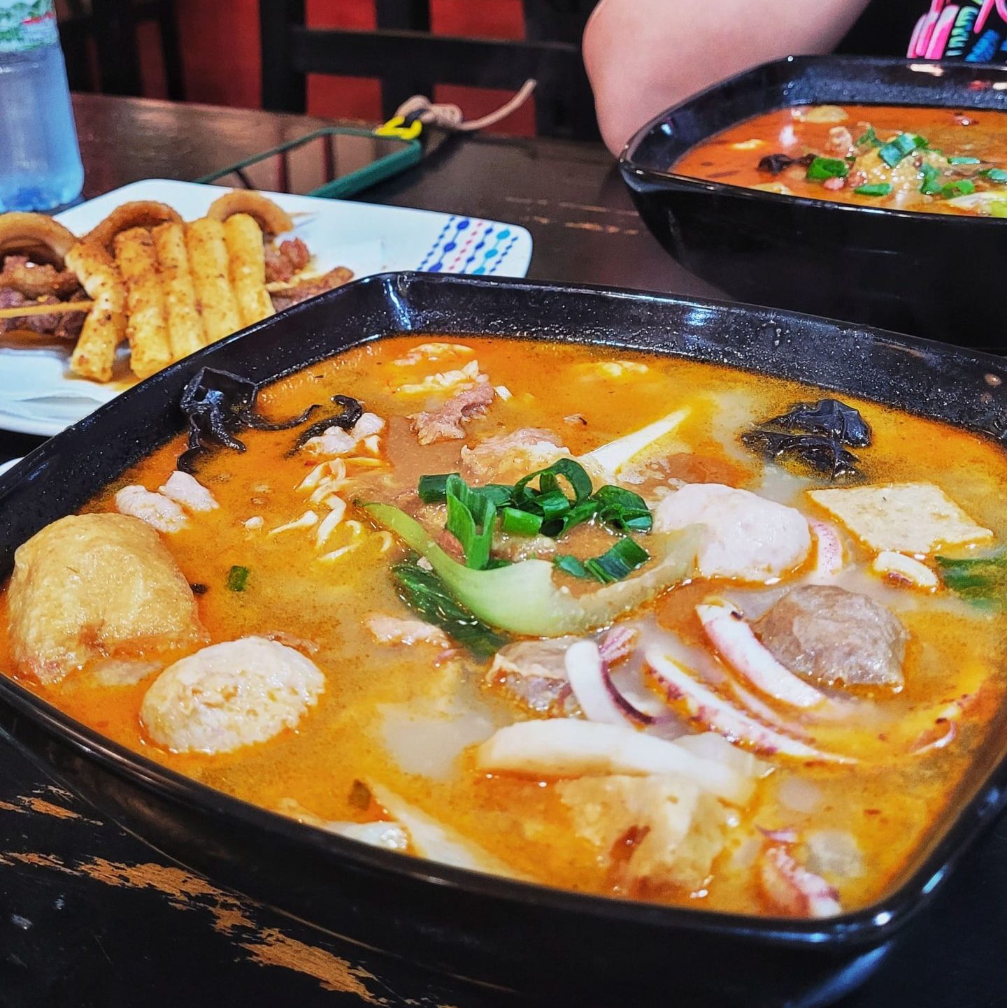 Malatang chino personalizado con mariscos, tofu, hongos y vegetales cocidos en caldo especiado